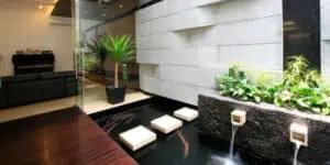 A modern living room with a STORMWATER RETENTION BASIN as a water feature.